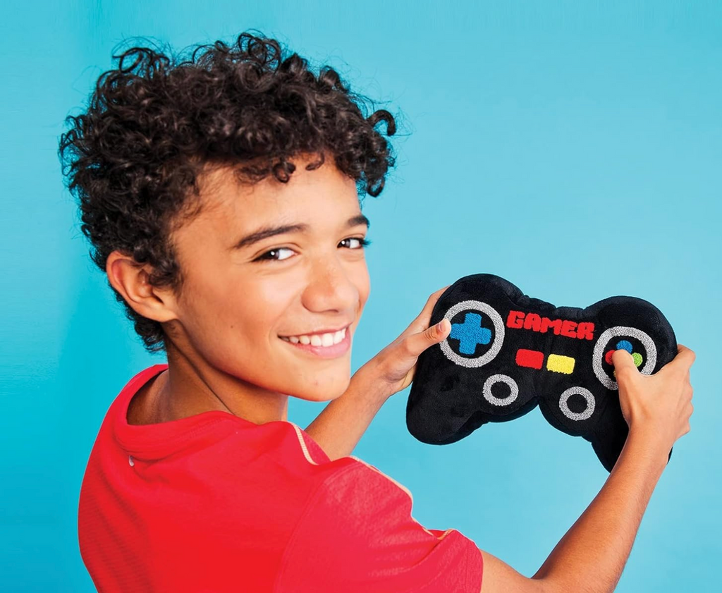 A young kid holding the plush toy game controller. 