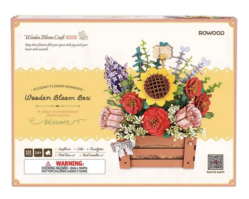 Wooden puzzle packaged in a box with color pictures showing the completed collection of flowers displayed in a wooden crate. 
