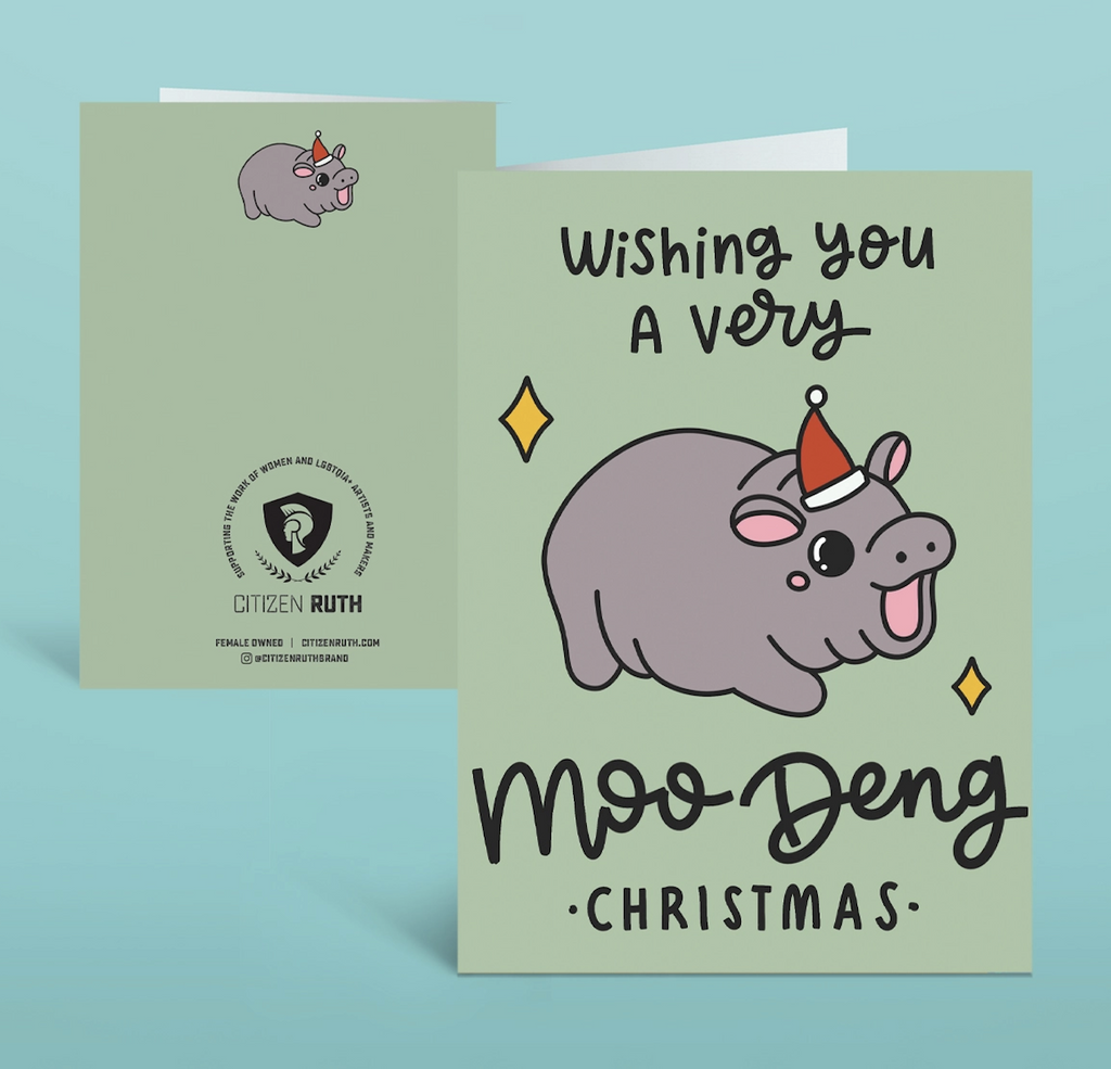 An illustrated greeting card with Moo Deng in a Santa hat that reads "Wishing you a Very Moo Deng Christmas"