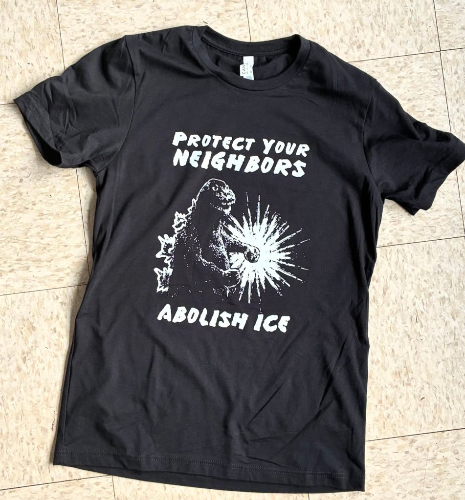 Screen printed black t-shirt with black and white image of Godzilla that reads "Protect Your Neighbors Abolish Ice" 