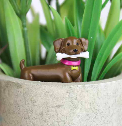 Close up view of an Adorable Dog Plant Marker in a plant. 