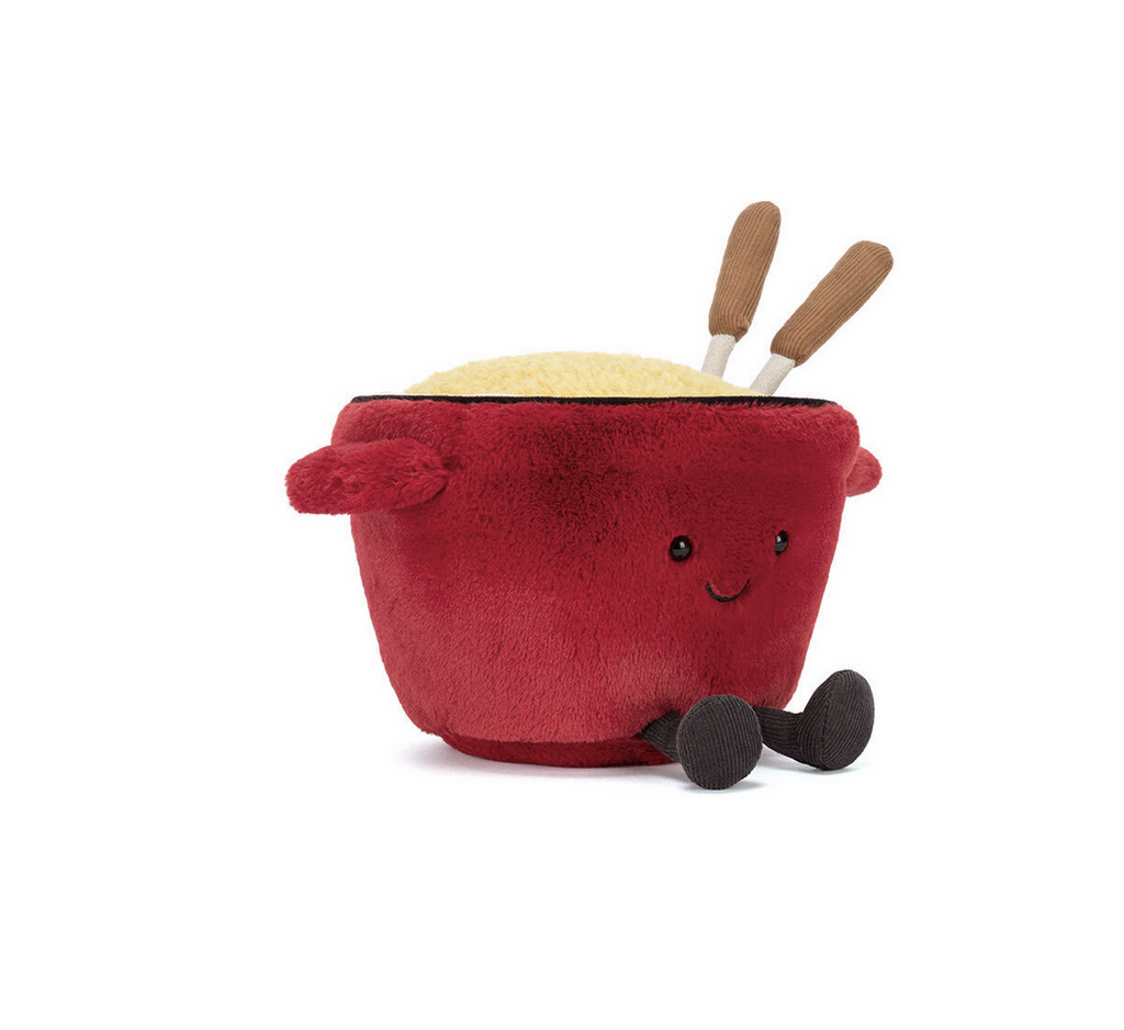 Plush toy red fondue pot with a happy face on a white background
