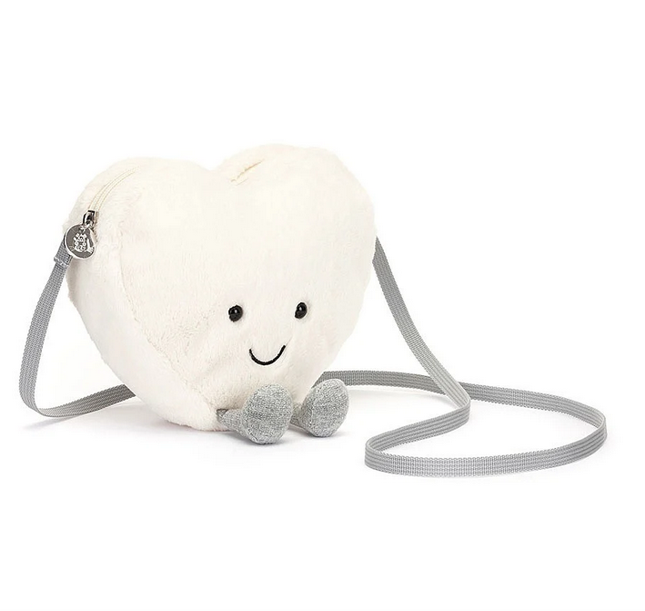 Plush cream heart bag with gray legs and strap.
