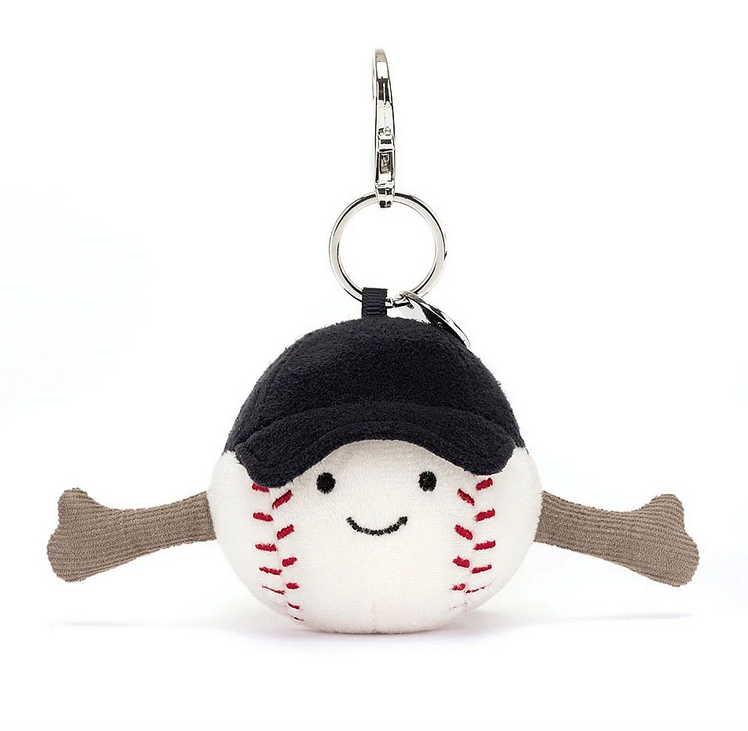 White plush baseball with red stitching and navy ball cap hanging from a silver clip.