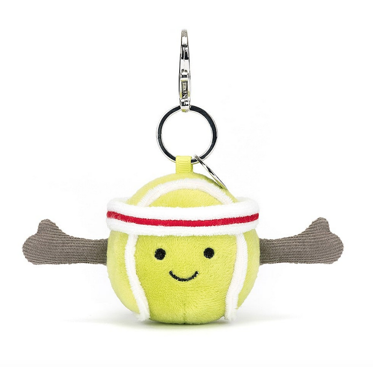 Plush tennis ball wearing a red and white striped headband with a silver clip.