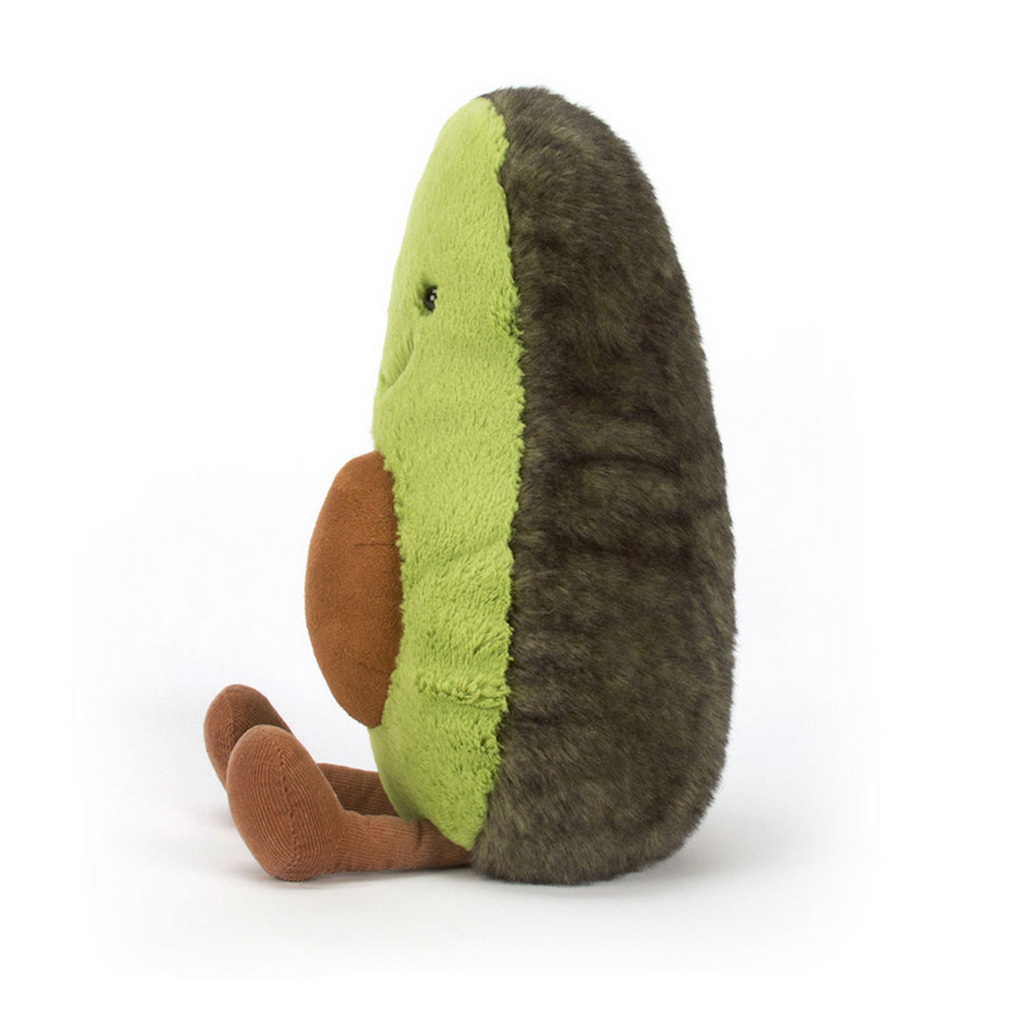 Side view of the Huge Amuseables Avocado plush from Jellycat. 