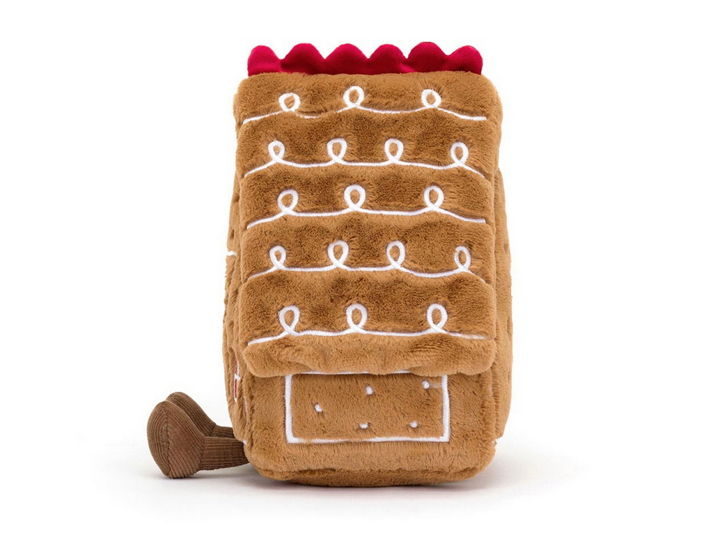 Plush gingerbread house toy on a white background