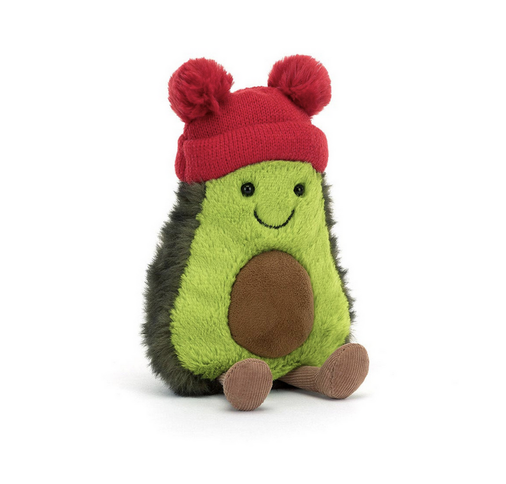 Plush Avocado wearing a red beanie with two pom poms on either side. 