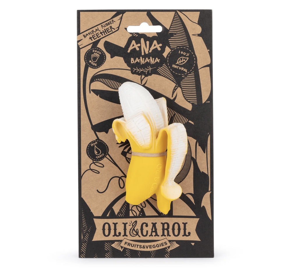 The Ana Banana Baby Teether from Oli & Carol attached to a cardboard hang card with illustrations of big banana leaves on the front. 