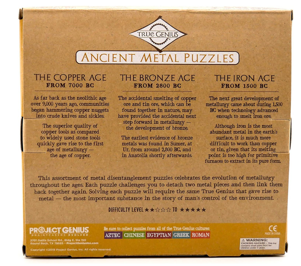 Back of Ancient Metal Puzzles box describing the Copper, Bronze, and Iron Ages. Following text reads: " This assortment of metal disentanglement puzzles celebrates the evolution of metallurgy throughout the ages. Each puzzle challenges you to detach two metal pieces and then link them back together again. Solving each puzzle will require the same True Genius that gave rise to metal- the most important substance in the story of man's control over the environment."