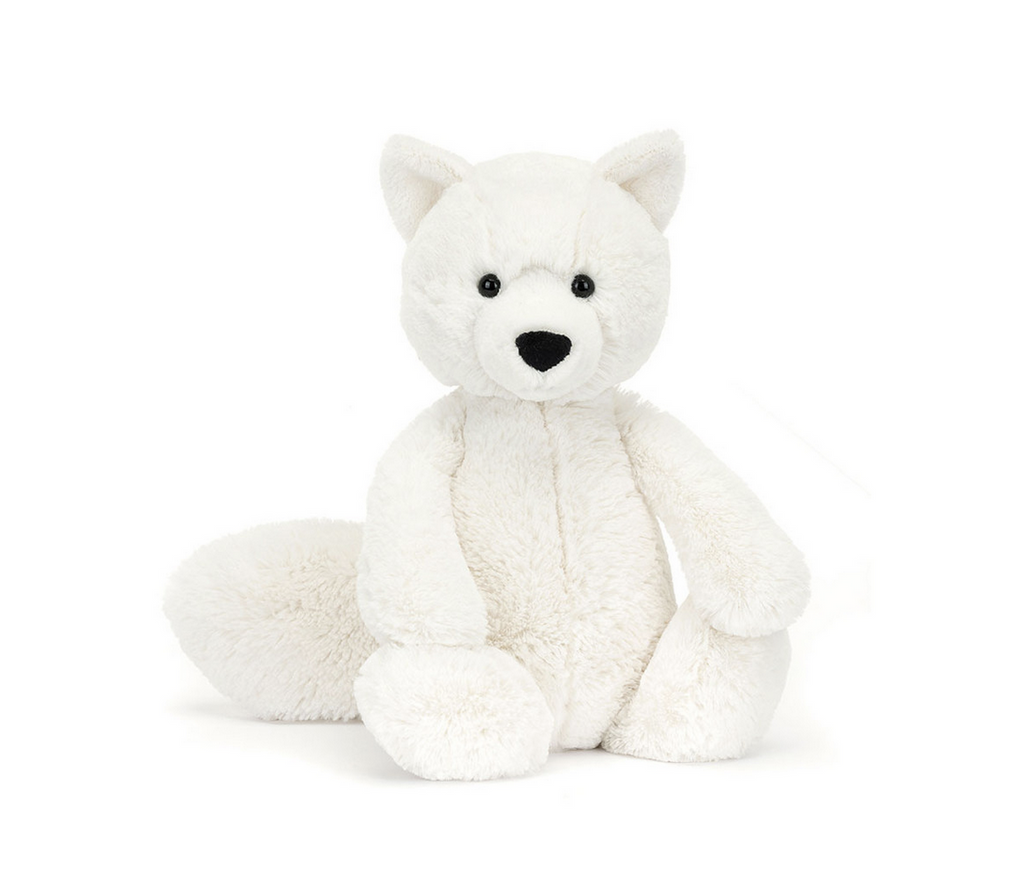 Seated white fox plush.