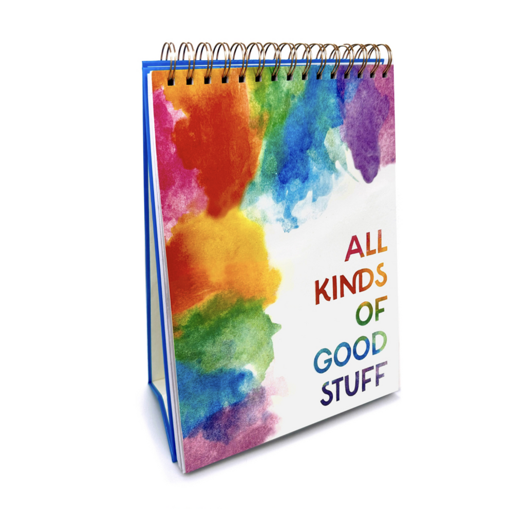 Easel watercolor pad standing on a white background. Front of pad has rainbow watercolor splotches and reads "all kinds of good stuff".