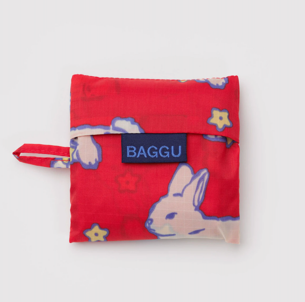 Baby Baggu reuseable tote folded neatly into the pouch that it is stored in. 
