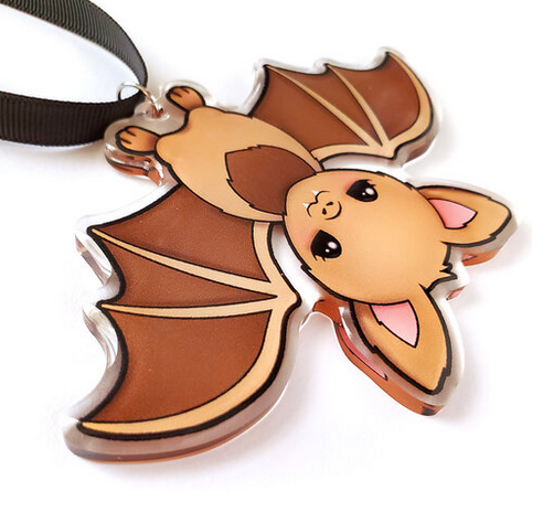 Baby Bat ornament is double sided. Printed on clear acrylic. 3.5" tall laying on a flat surface. . 