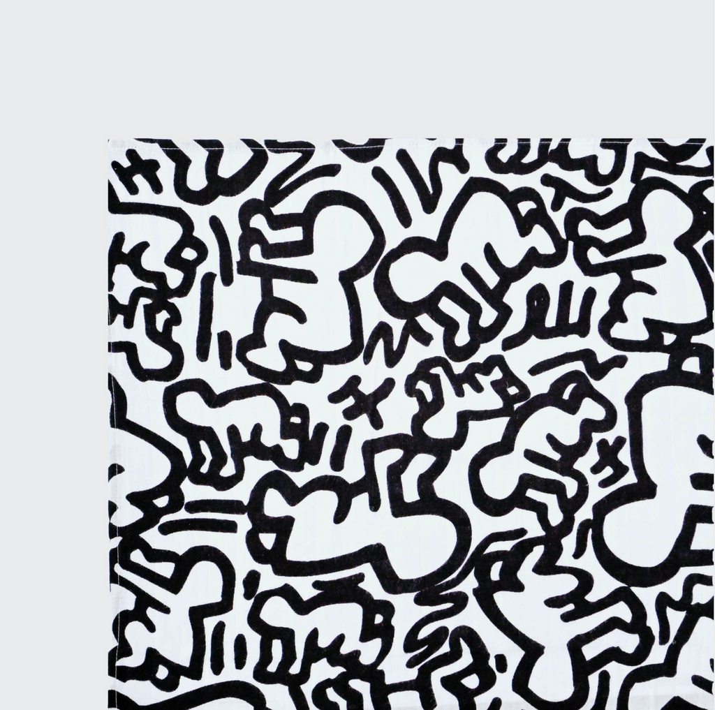Black and white Keith Haring "baby" print fabric square on a white background.