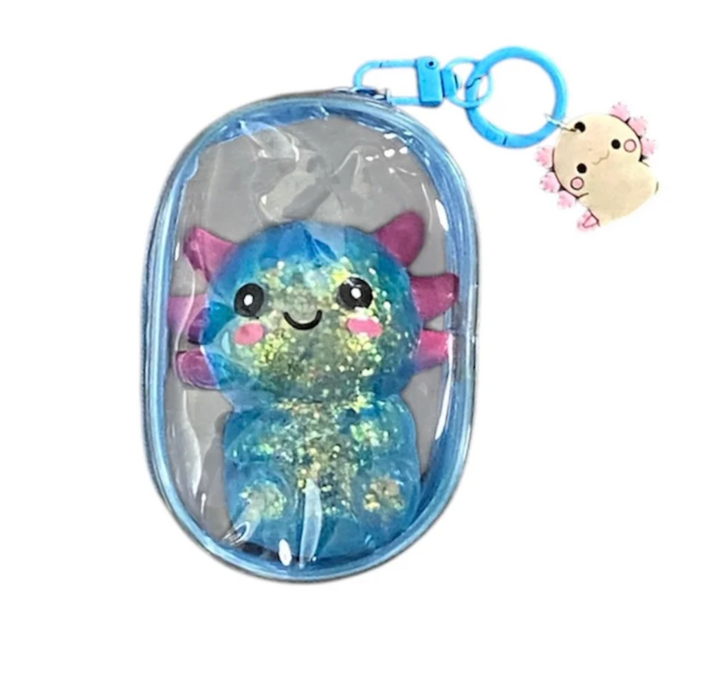 Close up of the blue Axolotl Backpack Buddiez stored in a clear bag with a clip to attach to any bag you choose. 