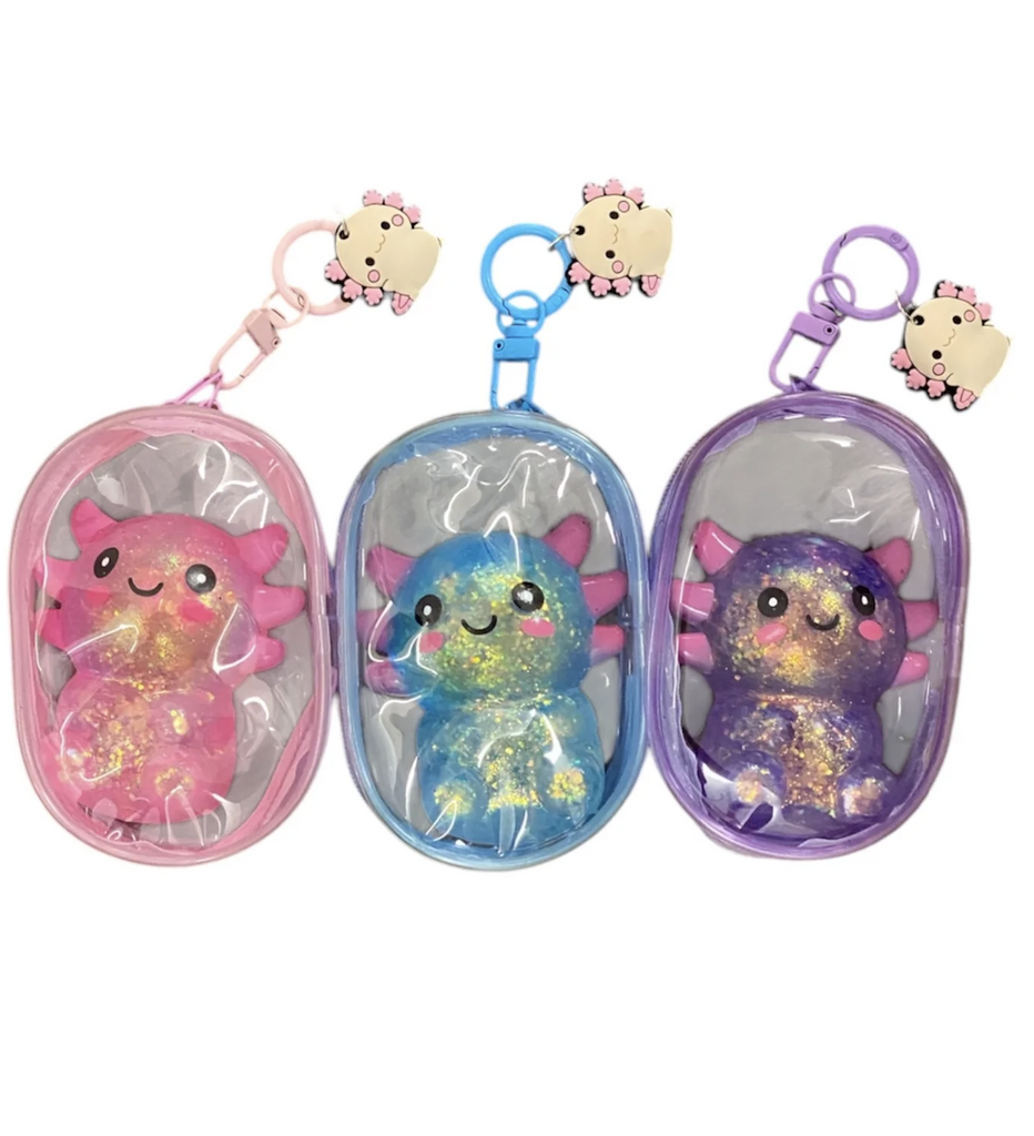 Pink, blue, and purple glitter Axolotl squish toys in their clear bags that attach to any backpack or bag. 