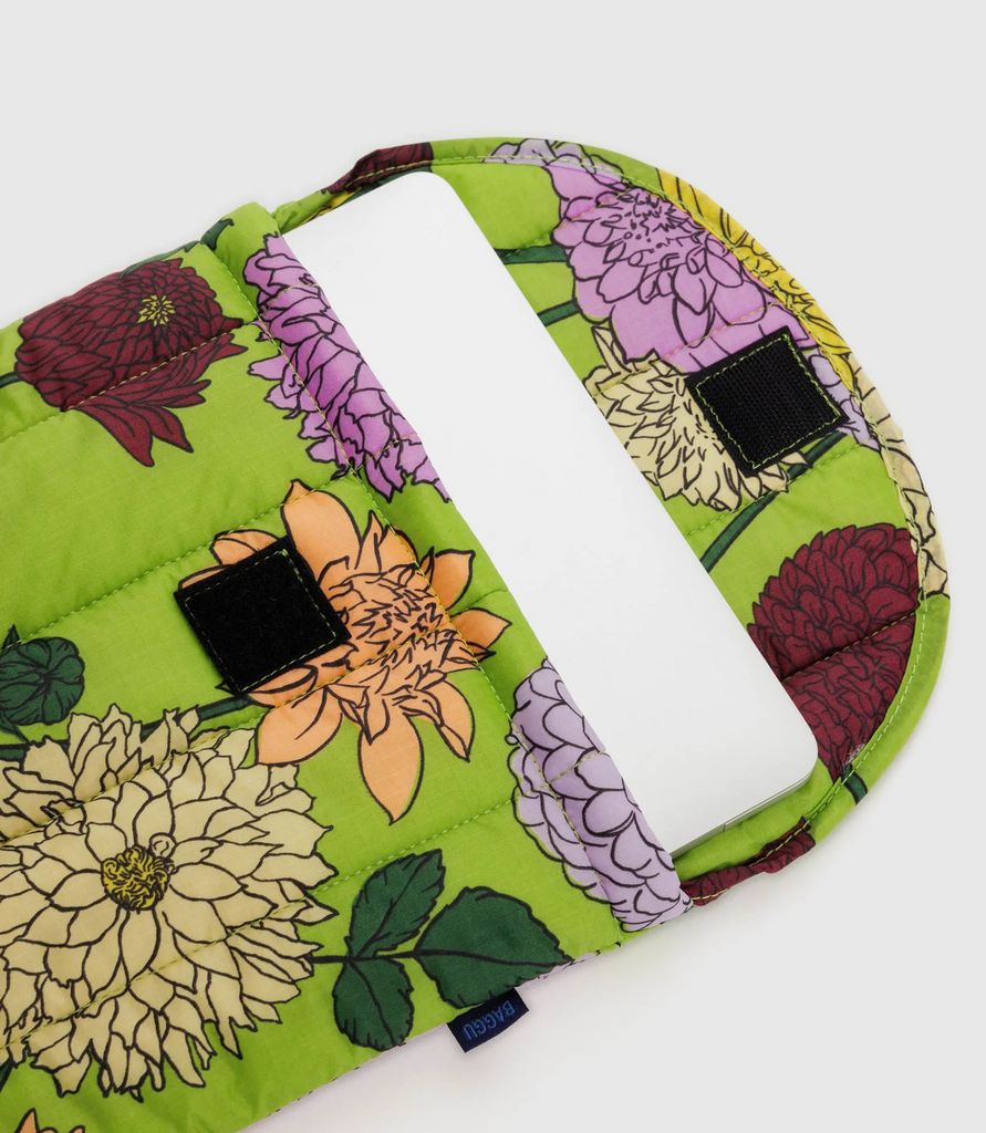 Dahlia puffy laptop sleeve open at the top to show the velcro closure. 