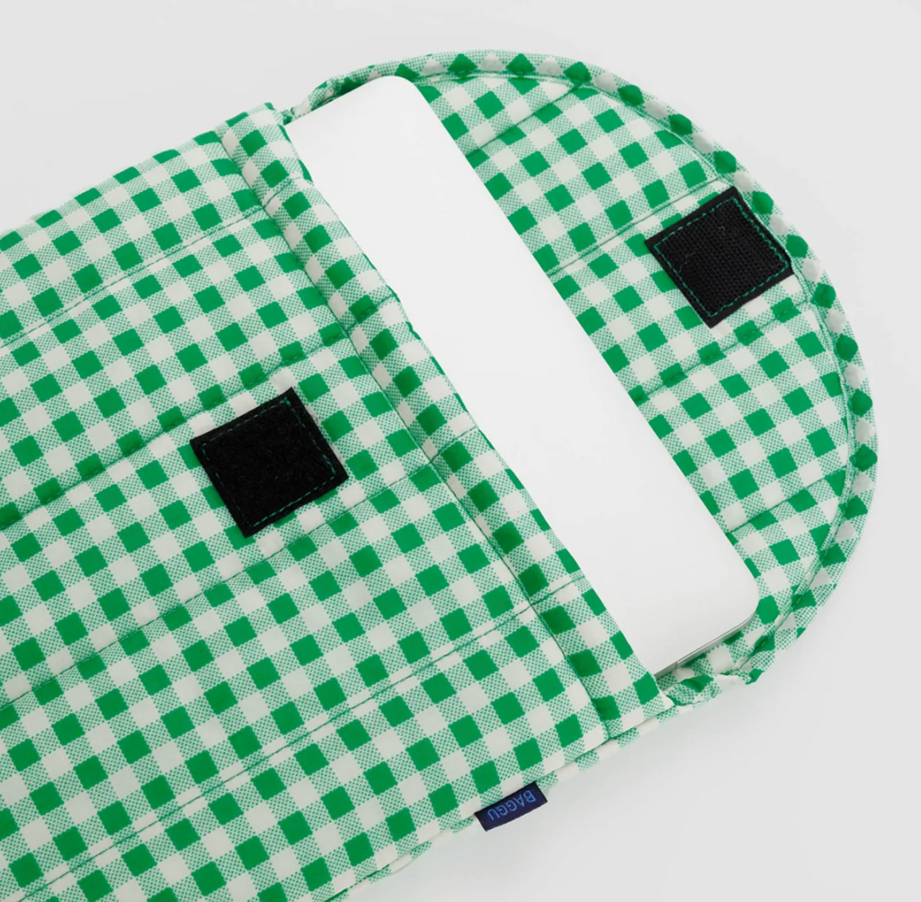 Green gingham puffy laptop sleeve open and showing the velcro closure. 