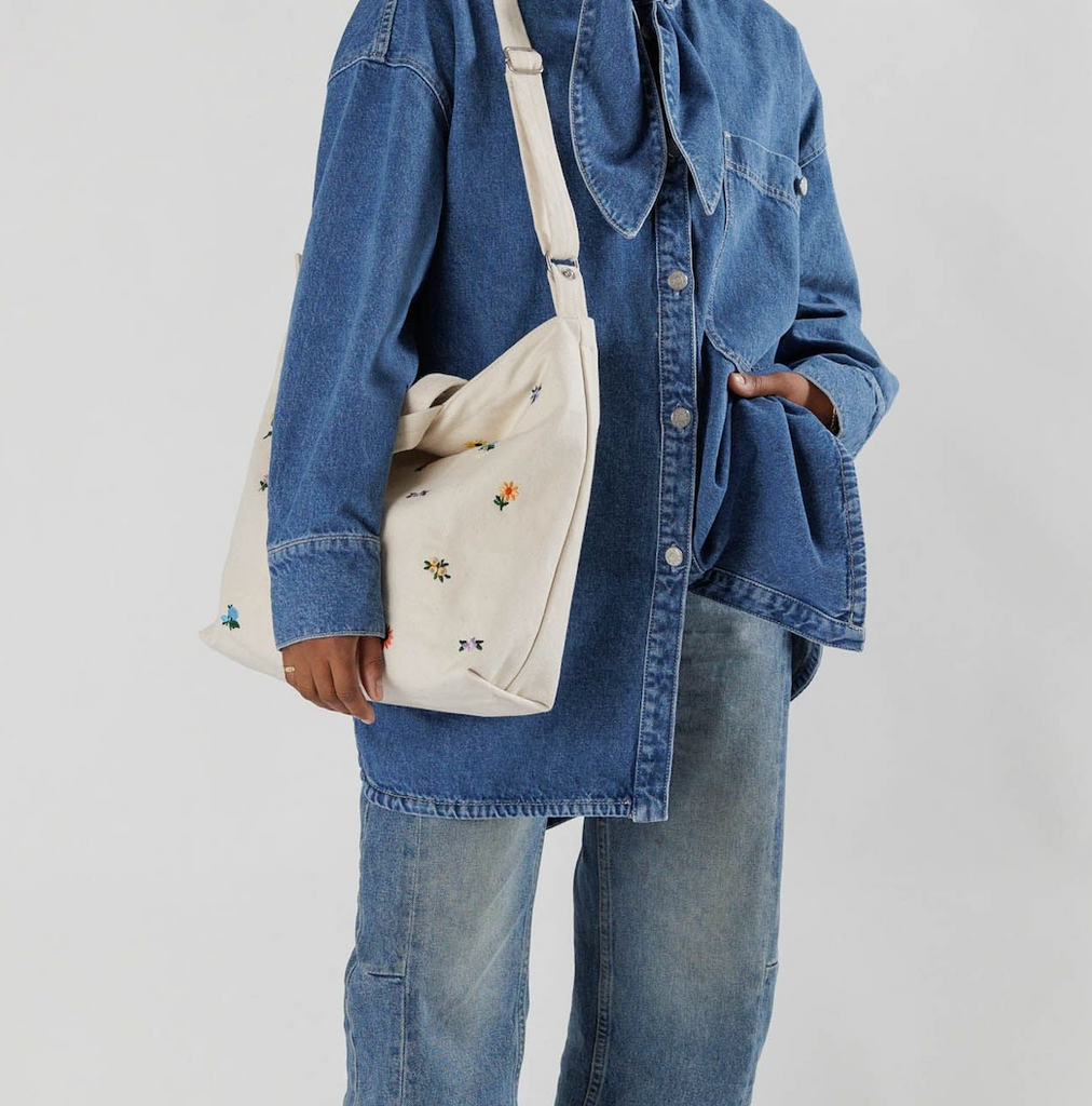 Canvas Horizontal Zip Duck Bag in Ditsy Floral worn on the shoulder.