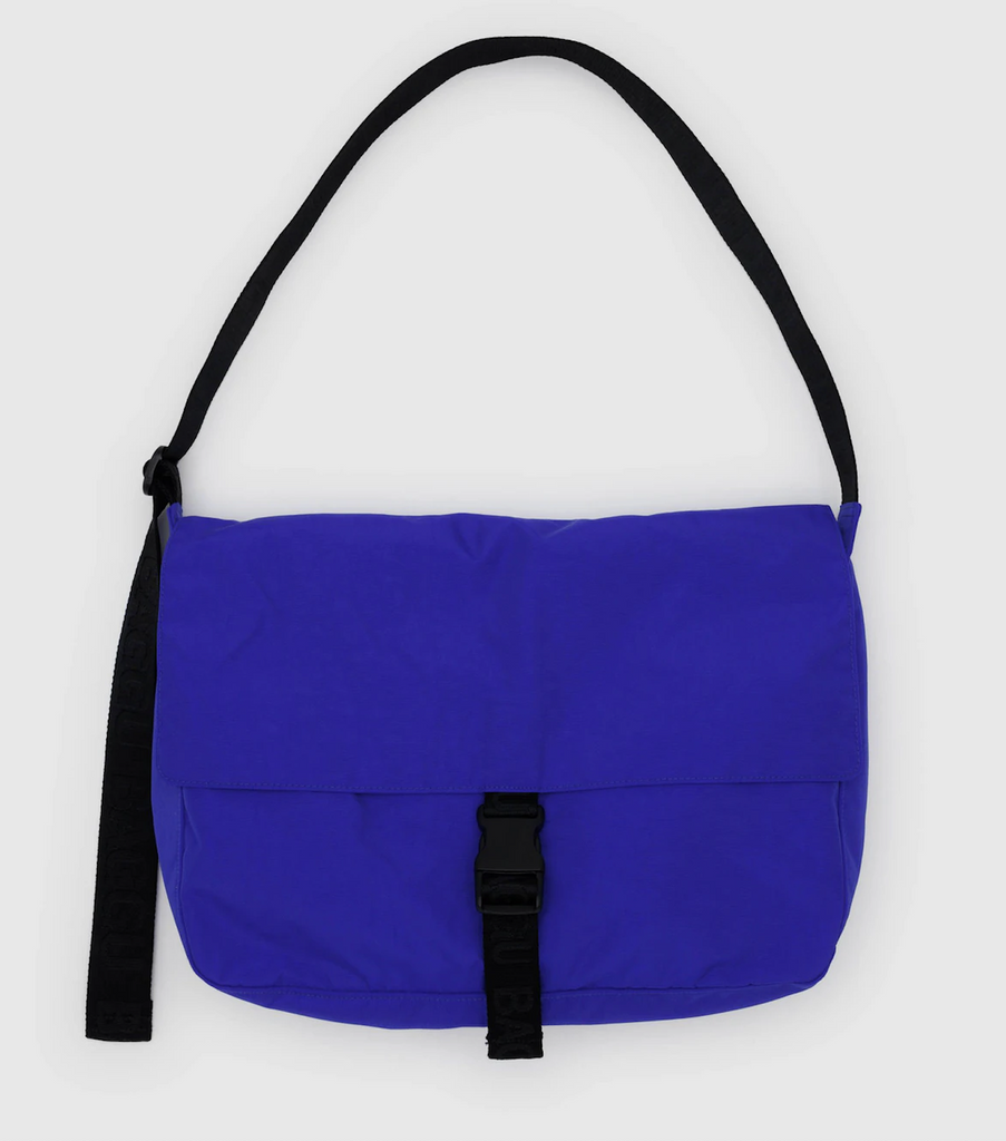 Lapis colored nylon messenger bag with black shoulder strap and front closure. 
