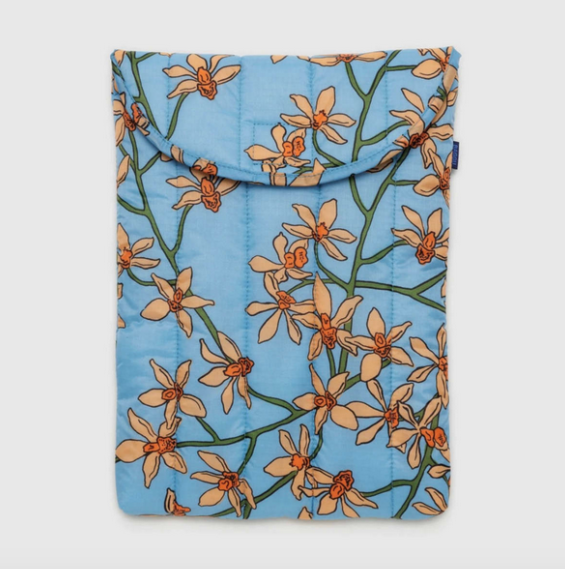 Puffy laptop sleeve with orange orchid pattern on a blue background. 