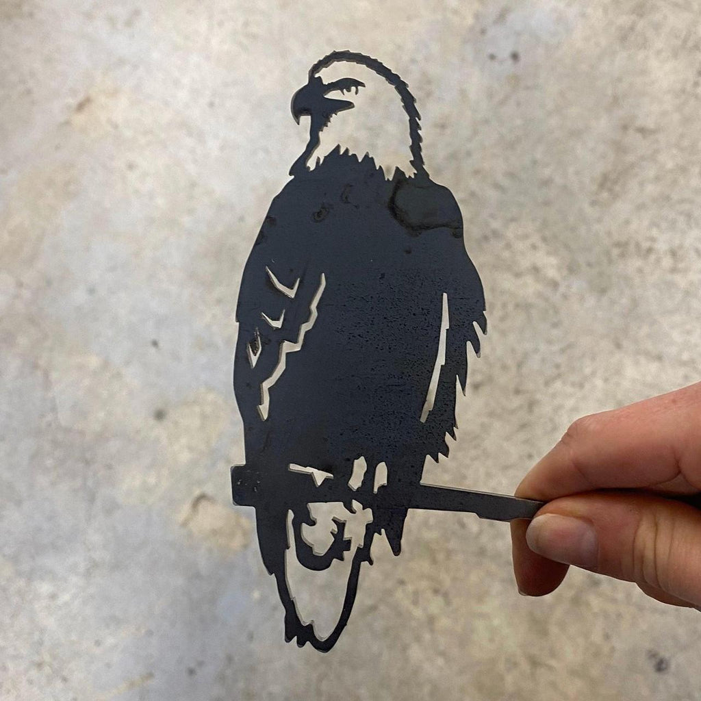 Silhouette of a bald eagle made of metal.