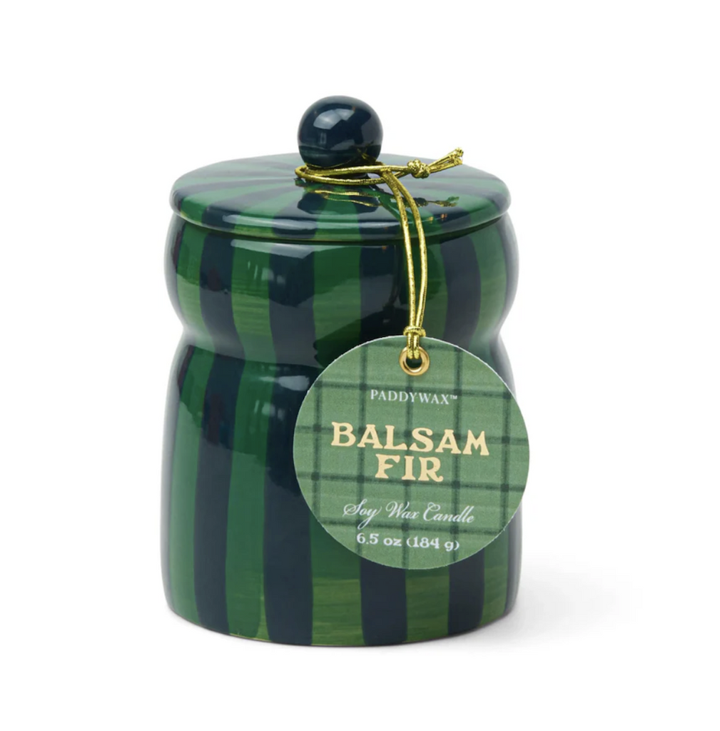 Ceramic hand-painted scented candle with two tone green stripes and topped with a functional lid. A green plaid tag that reads "Balsam Fir Soy Wax Candle" is hanging from the top. 