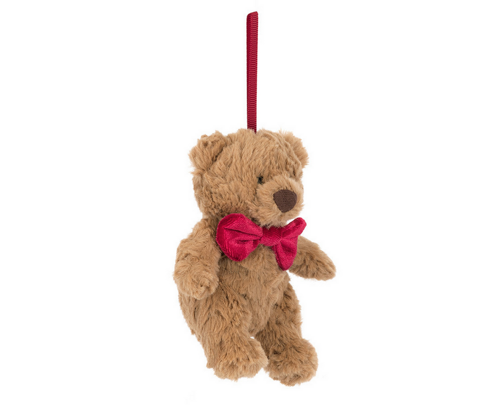 Plush teddy bear with a red bow tie ornament on a white background
