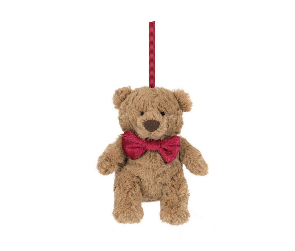 Plush brown bear with a red bowtie ornament on a white background.