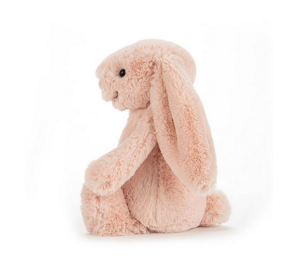 Bashful Blush Bunny plush viewed from the side with it's long lop ears hanging over it's side. 