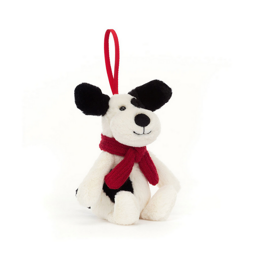 Bashful Puppy plush ornament wearing a red scarf and has a red ribbon to match. 