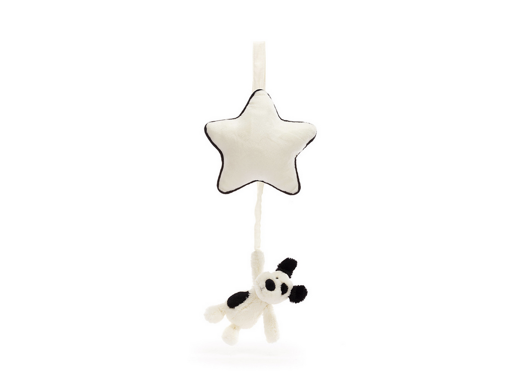 Cream colored plush star with a small plush black and cream puppy dog hanging from it. When you gently pull the dog a lullaby plays while he winds back up. 
