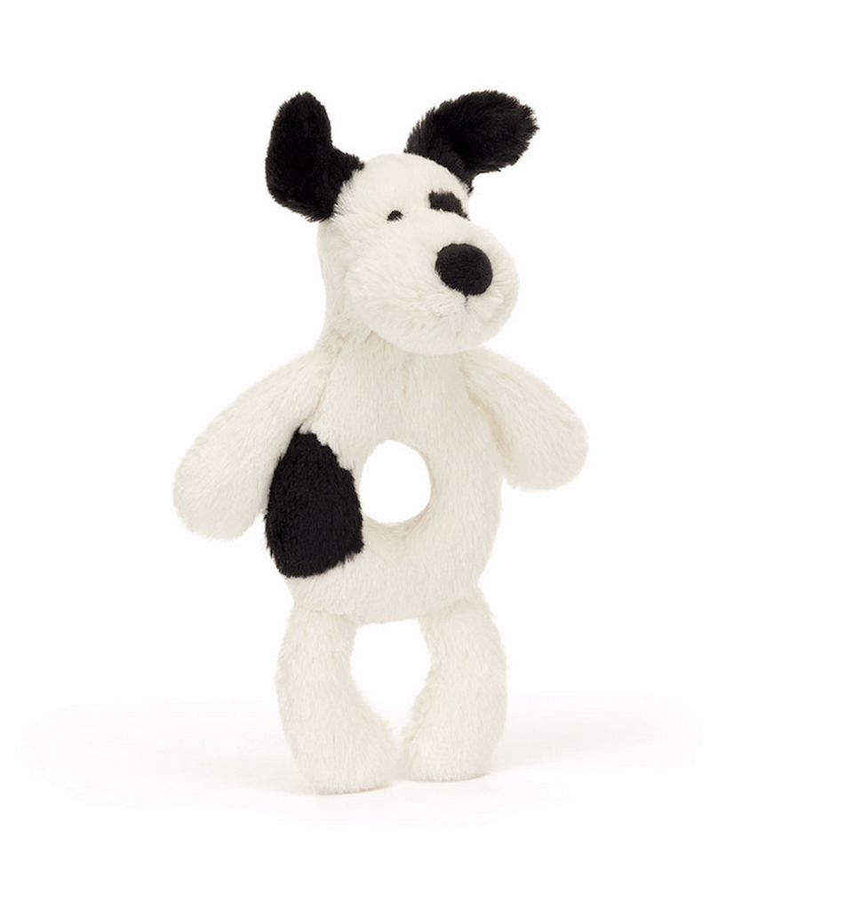 White and black puppy plush with ring rattle. 