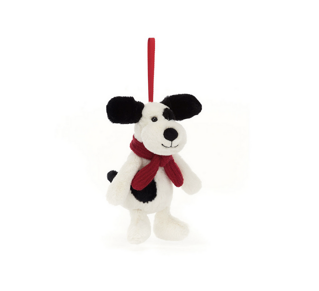 Jellycat plush Bashful Puppy Decoration with red ribbon to hang anywhere. The miniature version of the Bashful Puppy stuffed animal is wearing a red scarf to make anything more festive this holiday season. 