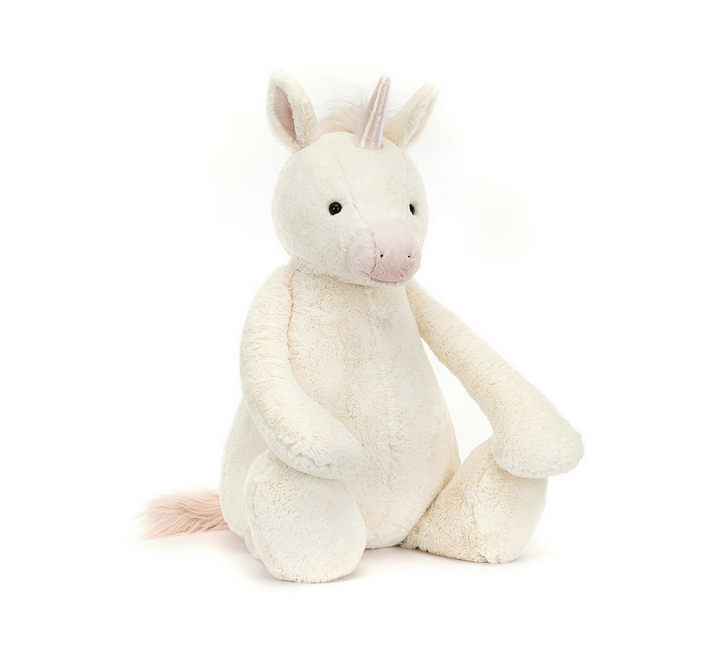 Bashful Unicorn Giant plush sitiing upright and facing forward. The unicorn is white with a glittery, silver horn and soft pink mane.