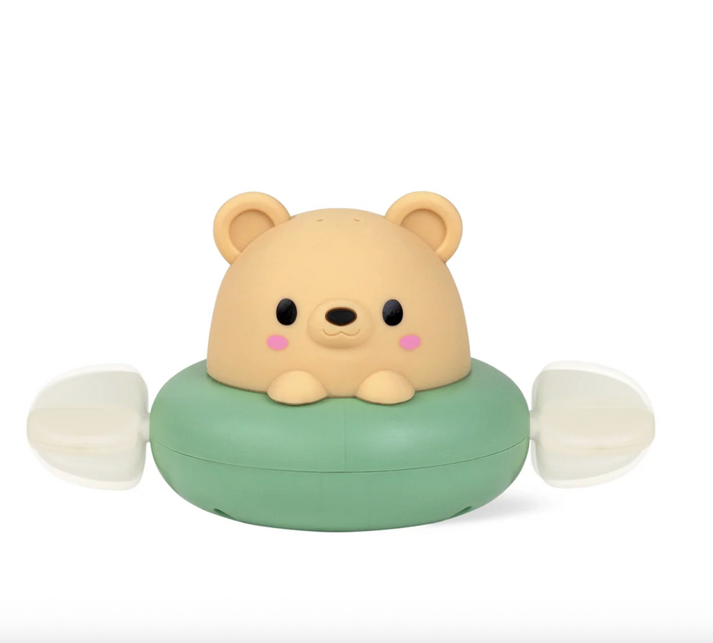 A close up picture of the Paddle Boat Bear bath toy, a cute brown bear in a green boat with paddles on either side. 