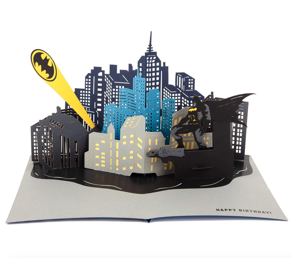 The Batmobile Pop Up Birthday card open to show the intricate scene of Batman looking over Gotham City at the Bat Signal. 