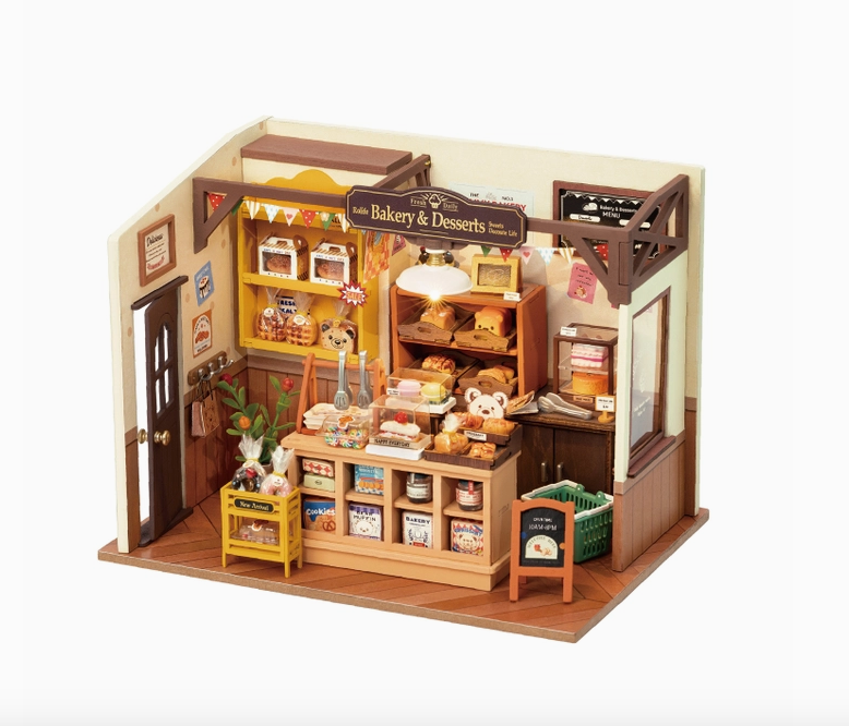 The completed model of Becka's Baking House with miniature shelves, working lights and pastries. 