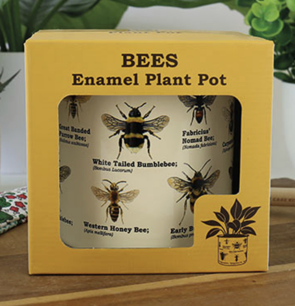 The Bees Enamel Plant Pot packaged in a yellow box with open sides to show all the illustrations of bees on the planter. 