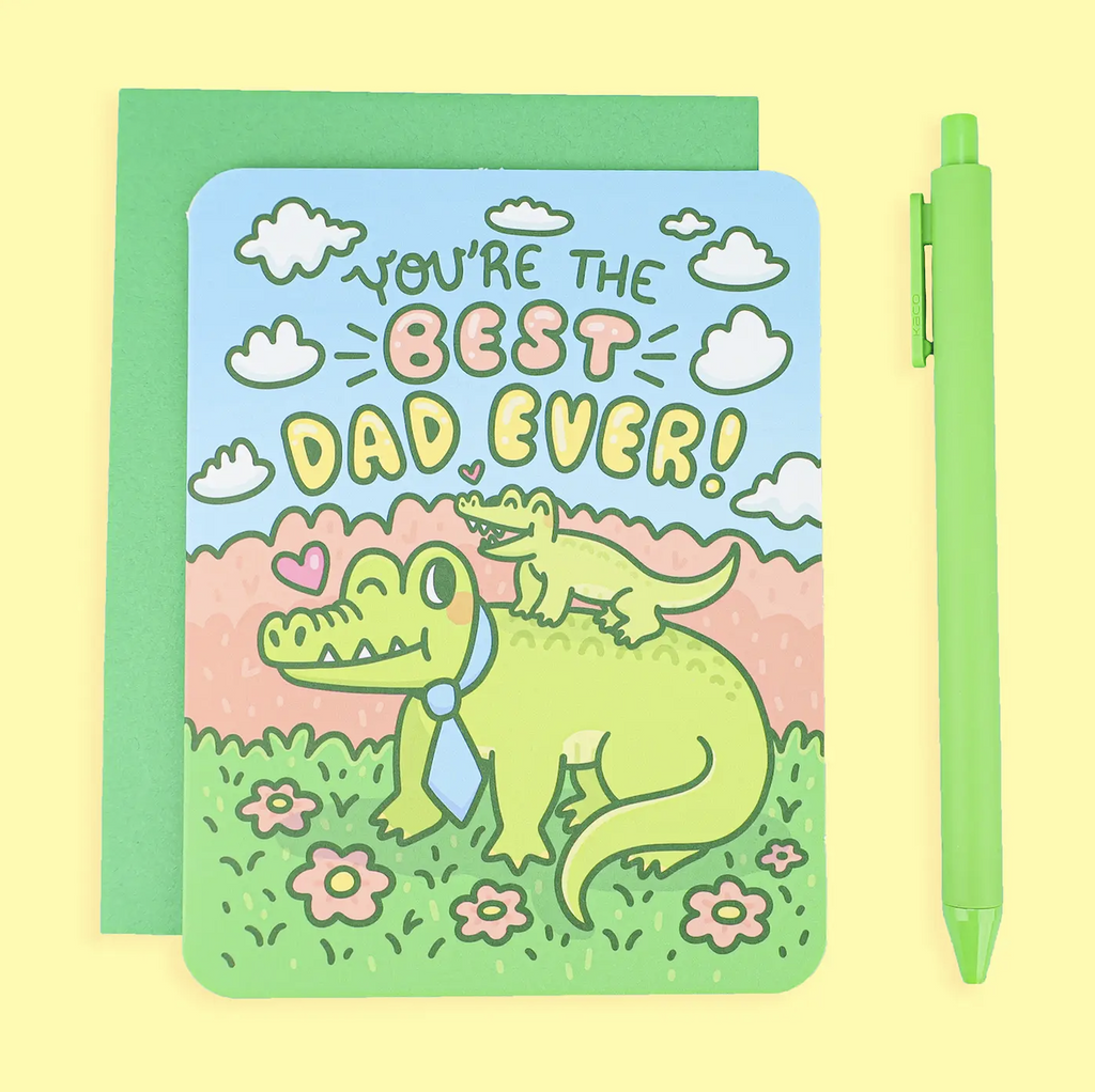 Brightly, colored greeting card with an illustration of an alligator wearing a tie with a baby alligator riding on his back that reads "You're the Best Dad Ever!" 