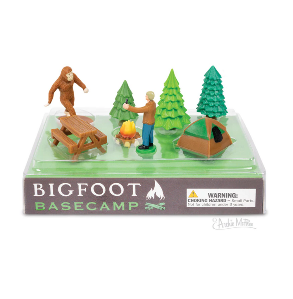 Figures include Bigfoot, picnic table, tent, campfire, 3 evergreen trees, and a man.