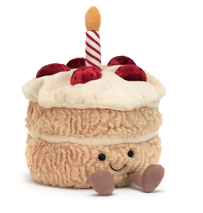The cutest little birthday cake plush. Cream colored frosting with delicate strawberries on the top with a red and white striped candle.  