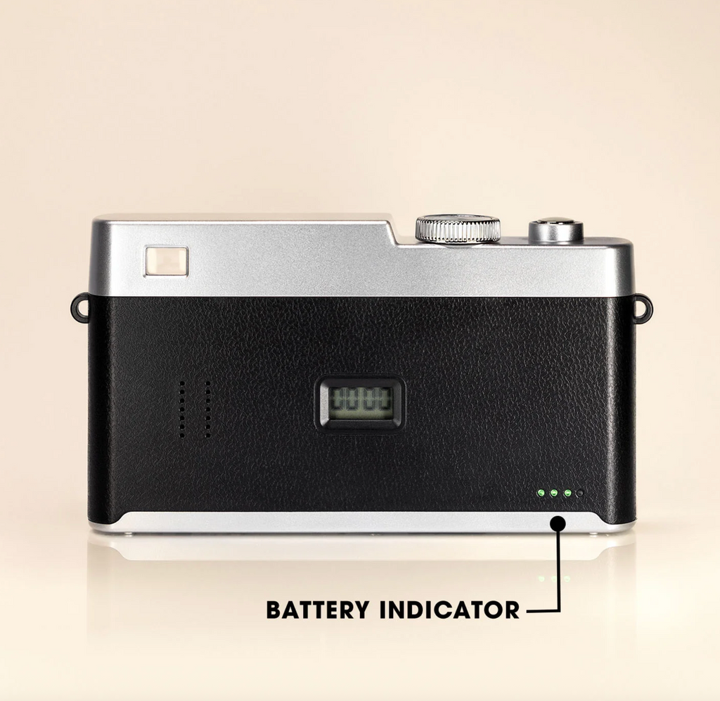 Camera with battery indicator labeled on a beige background