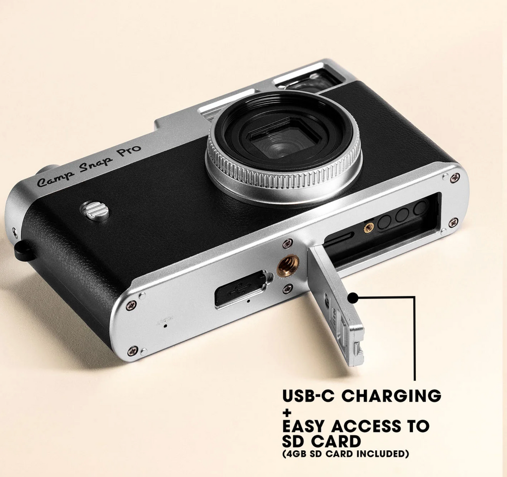 Camera with USB-C charging and SD card access on a beige background