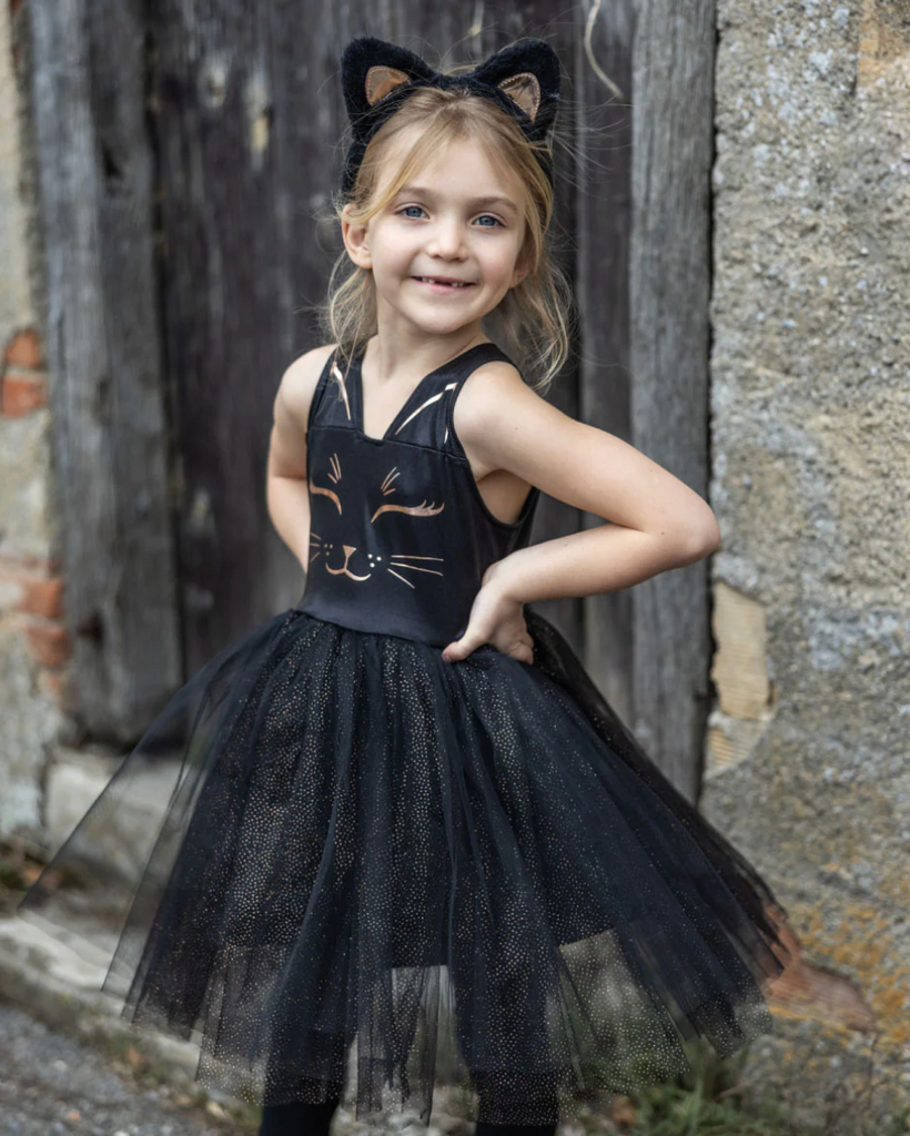 A kid wearing the Black Cat Dress and Headband. 