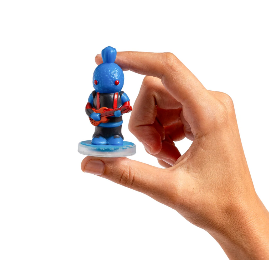 Bloop a small blue toy figure with red eyes and red suspenders holding a red guitar. Bloop is a solo figure used to expand the musical possibilities of the Loops Lab music system. 