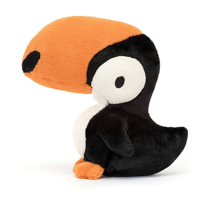 Side view of the Bodacious Beak Toucan plush with immaculate fur in tangerine, cream and liquorice, with a dapper bib, black beak marks, a perky tail and soft orange claws.