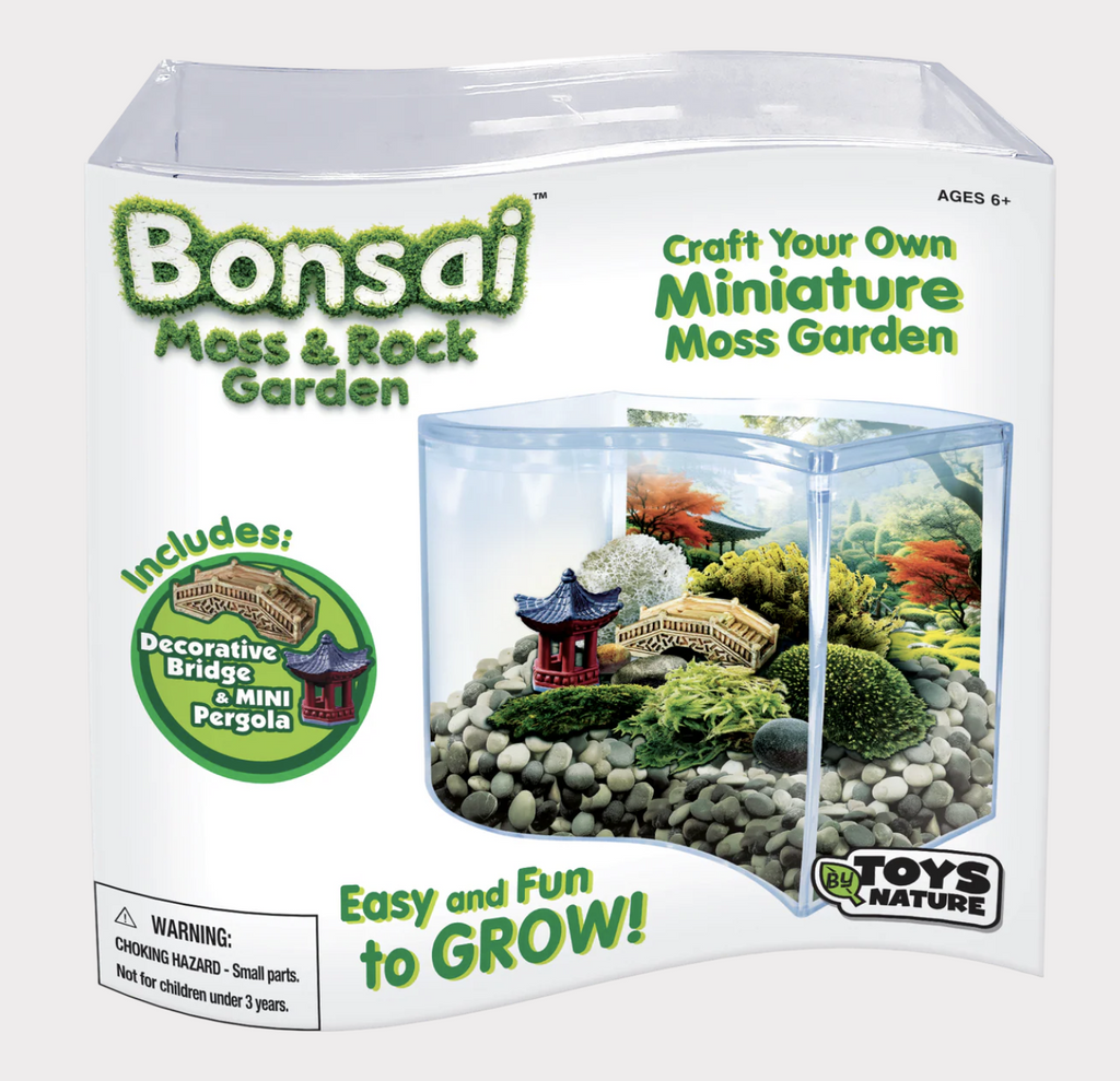 Bonsai Moss & Rock Garden packaged in a white box with a picture of the wave terrarium filled with rocks, moss and the decorative bridge and mini pergola that are included. 