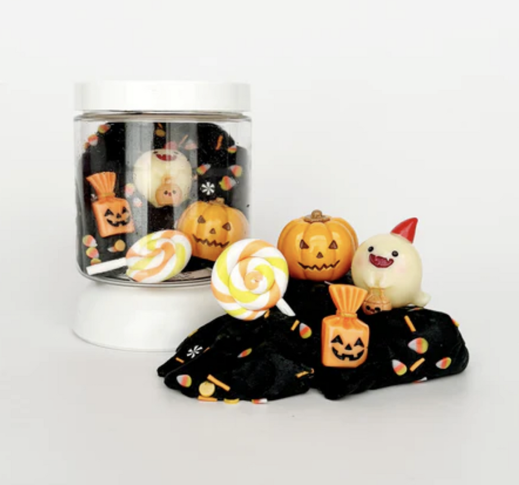 Boo Bash Mini Dough To Go putty with Halloween themed pieces like pumpkins, candy, and candy corn.